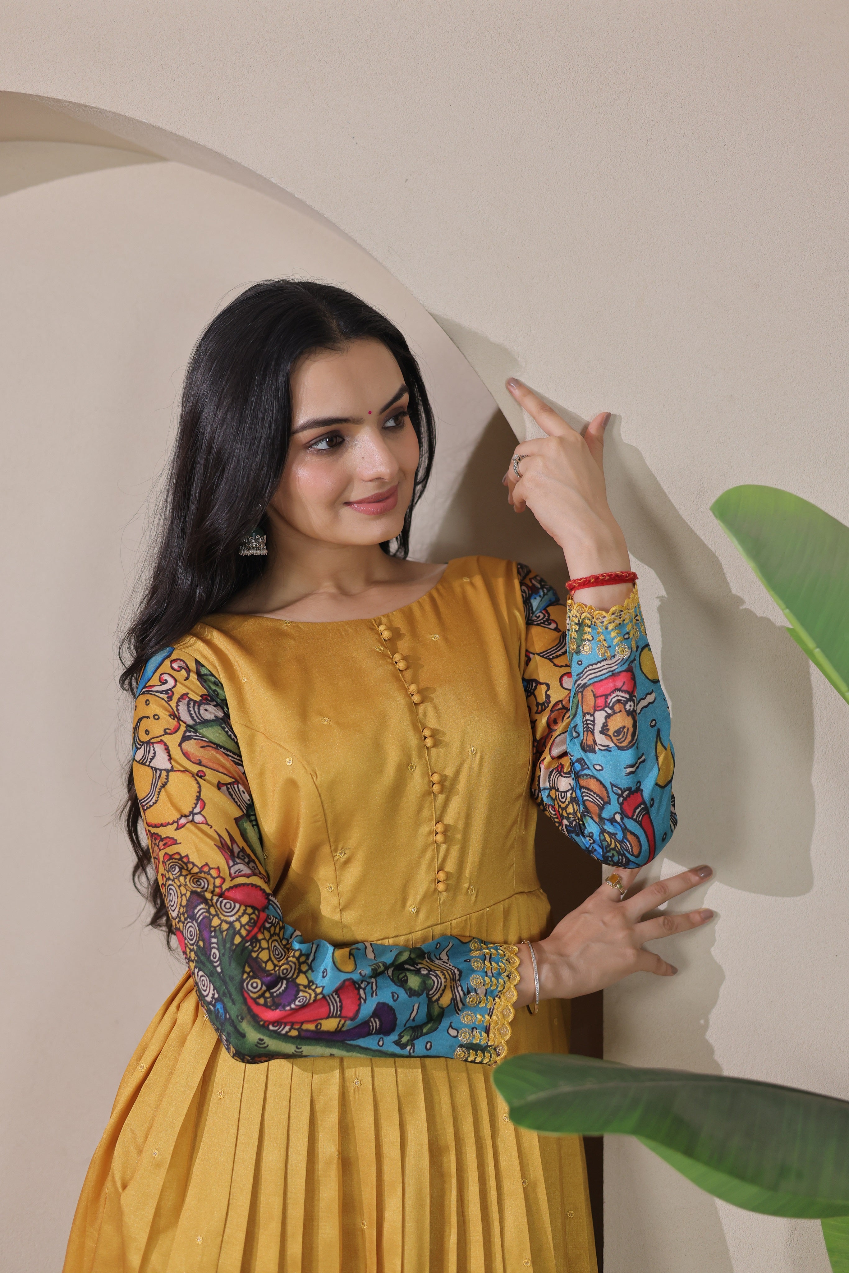 Mustard Yellow Tussar Silk Flared Gown with Kalamkari Figurative Art Border & Potli Buttons