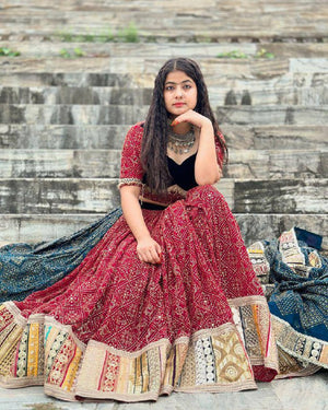 Maroon Red heavy muslin cotton Navratri lehenga choli with bandhani digital print, real mirror work embellishments, and a contrasting teal blue printed dupatta