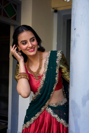 Red South Indian half saree with temple zari border and embroidered green dupatta