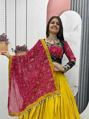 Garba chaniya choli mustard yellow with black embroidered border and rani pink bandhani dupatta