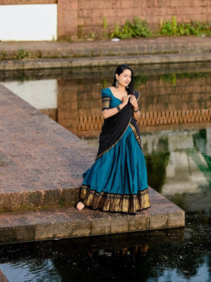 Traditional half saree with woven gold zari border teal black
