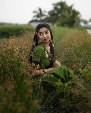 Earthy olive green South Indian half saree lehenga with black contrast