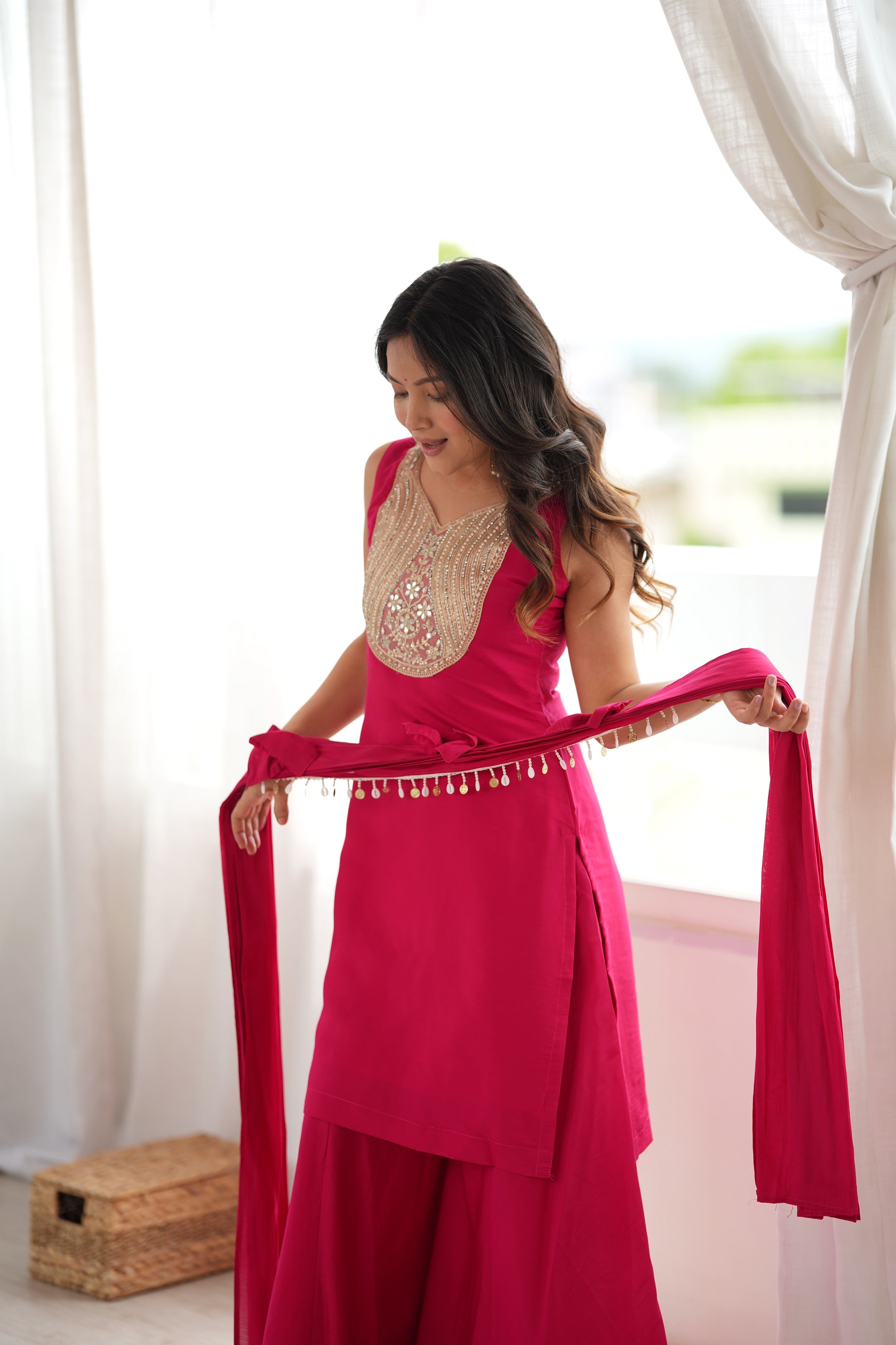 Rani Pink Roman Silk Sharara Suit Set with Real Mirror & Zari Work Neckline, Sleeveless Kurti, Flared Palazzo Pants & Attached Pleated Shoulder Drape Dupatta