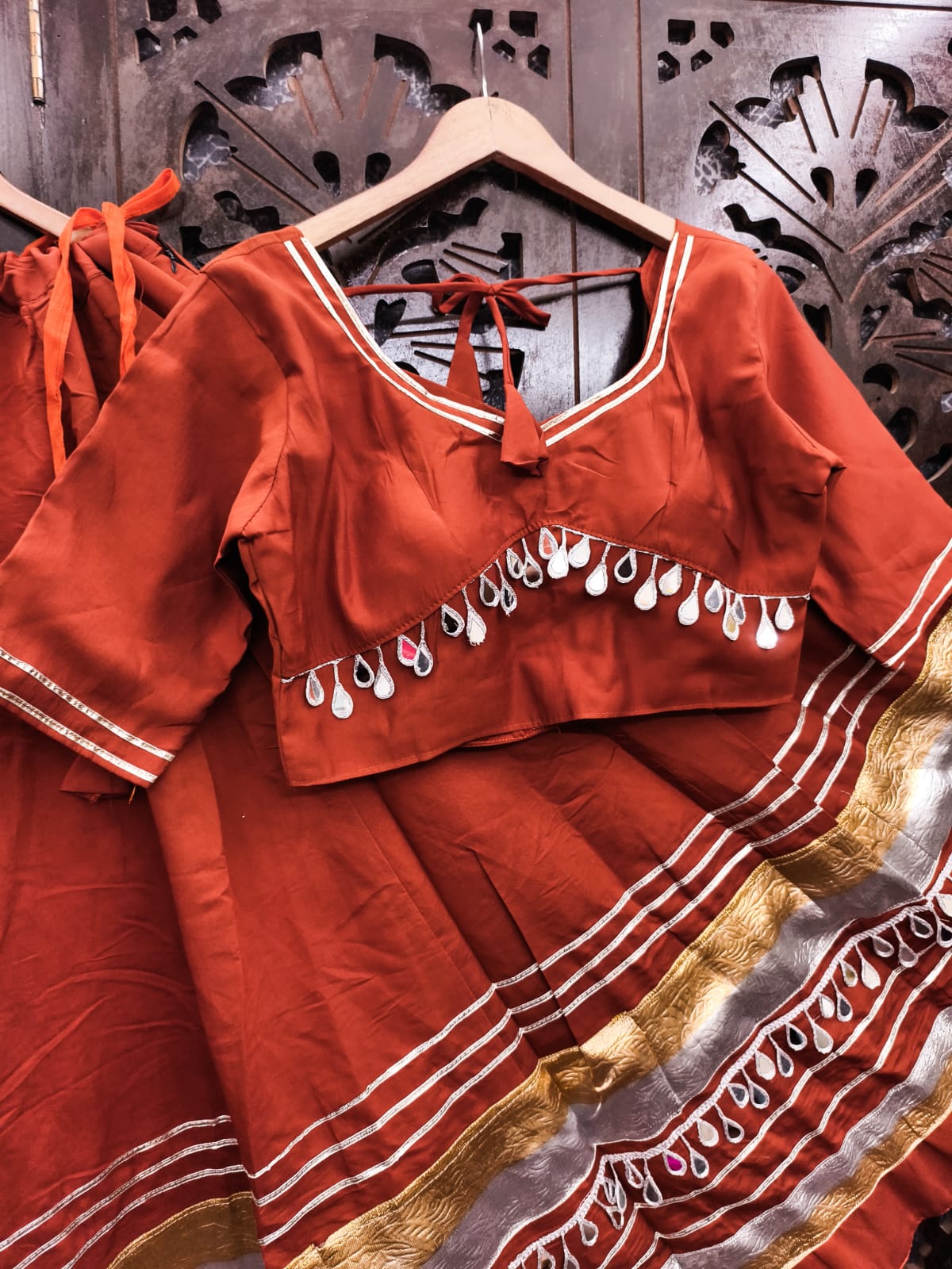 Rust Terracotta Pure Cotton Navratri Special Kalidar Flared Lehenga Choli Set with Dual-Tone Gold & Silver Lappa Borders, Original Teardrop Real Mirror Lace Work & Back Tie-Up Choli