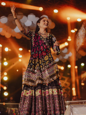 Singer Performing On Stage In Black Heavy Muslin Cotton With Canvas Patta & Real Mirror Work Navratri Lehenga Choli Set By The Beauty Queen