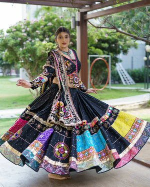 Model Wearing Black Heavy Muslin Cotton Gamthi Patchwork And Real Mirror Work Navratri Lehenga Choli Set By The Beauty Queen