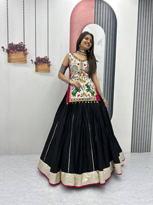 Model wearing Black and Off-White Motedo Heavy Gamthi Work with Real Mirror Work Navratri Special Long Top Chaniya Choli Set by The Beauty Queen