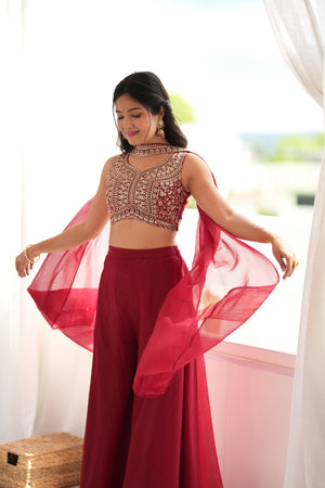 Model posing in a Maroon Red Pure Crunch Silk Palazzo Set with Heavy Thread and Sequin Embroidered Crop Top by The Beauty Queen