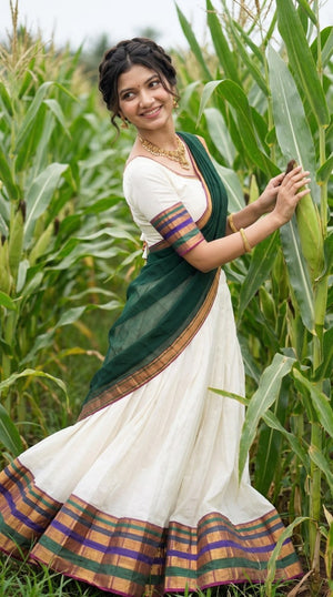 Off-White and Dark Bottle Green Mul Cotton Zari Weaving Work South Indian Half Saree Langa Voni Set flat lay view by The Beauty Queen