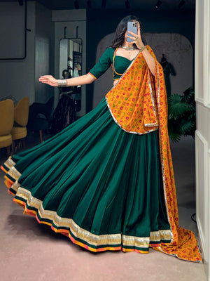 Model wearing Bottle Green & Mustard Yellow Crafted In Soft Chinon Fabric, Enhanced With Embossed Design Lace Navratri Lehenga Choli Set by The Beauty Queen