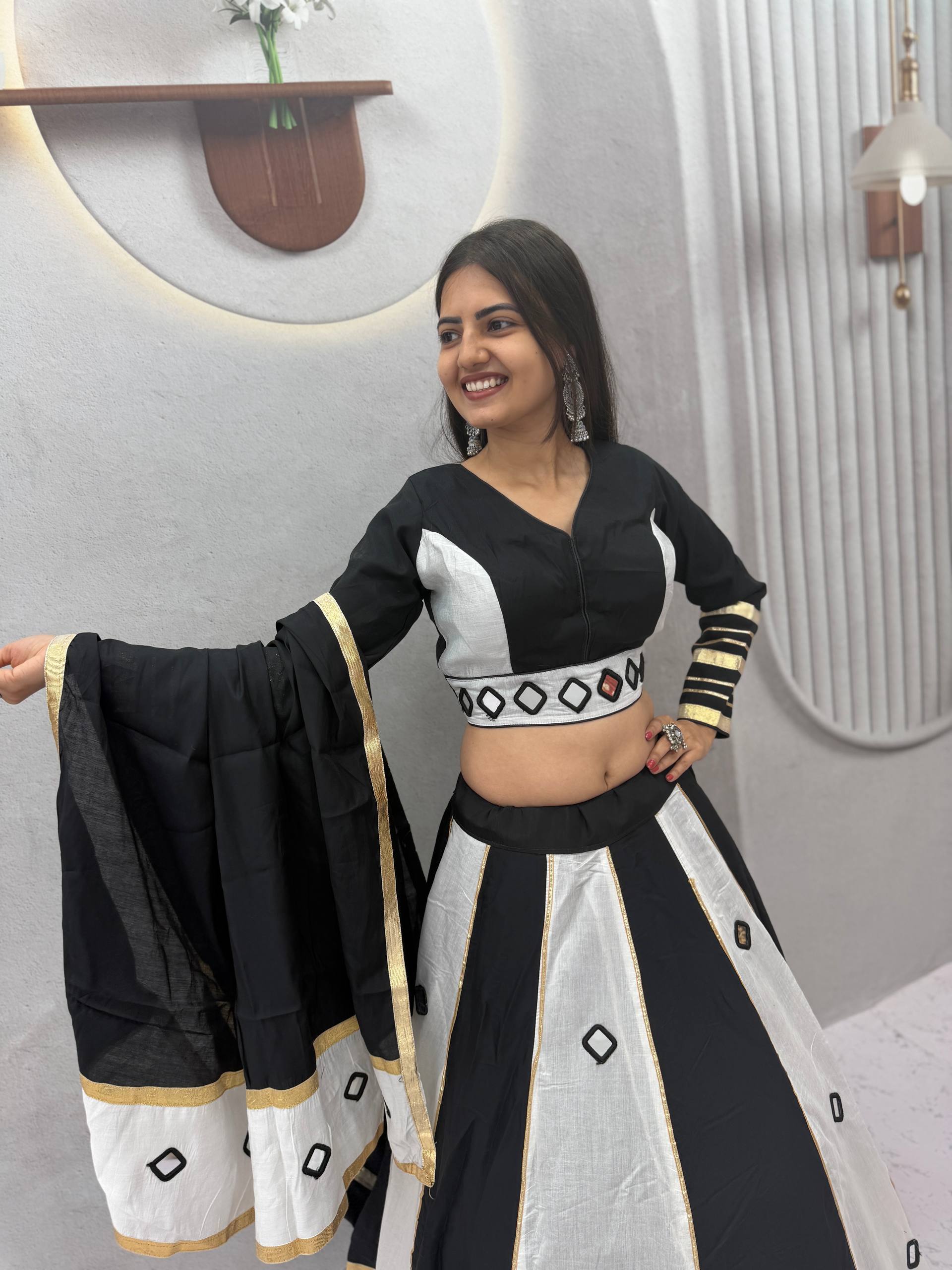Monochrome Jet Black & Off-White Color-Blocked Roman Silk Navratri Special Flared Lehenga Choli Set with Real Mirror Work, Gold Gota Patti Borders, Full-Sleeve Blouse & Matching Dupatta