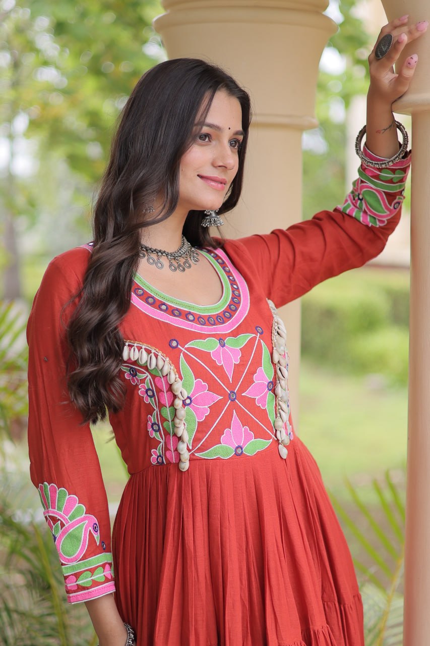 Rust Terracotta Orange Kora Cotton Navratri Special High-Flare Tiered Gown with Multi-Thread Floral Embroidery, Real Mirror Work & Authentic Cowrie Shell (Codi) Embellishments