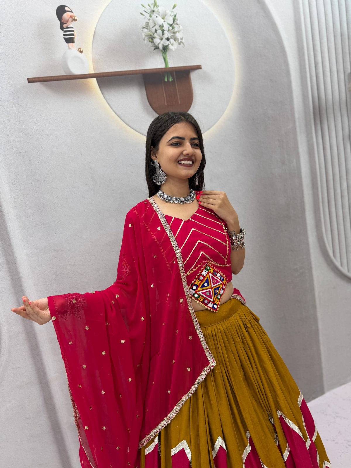 Mustard Yellow & Rani Pink Rayon Cotton Zig-Zag Chevron Pattern Navratri Special Flared Lehenga Choli Set With Real Mirror Work Blouse & Dupatta