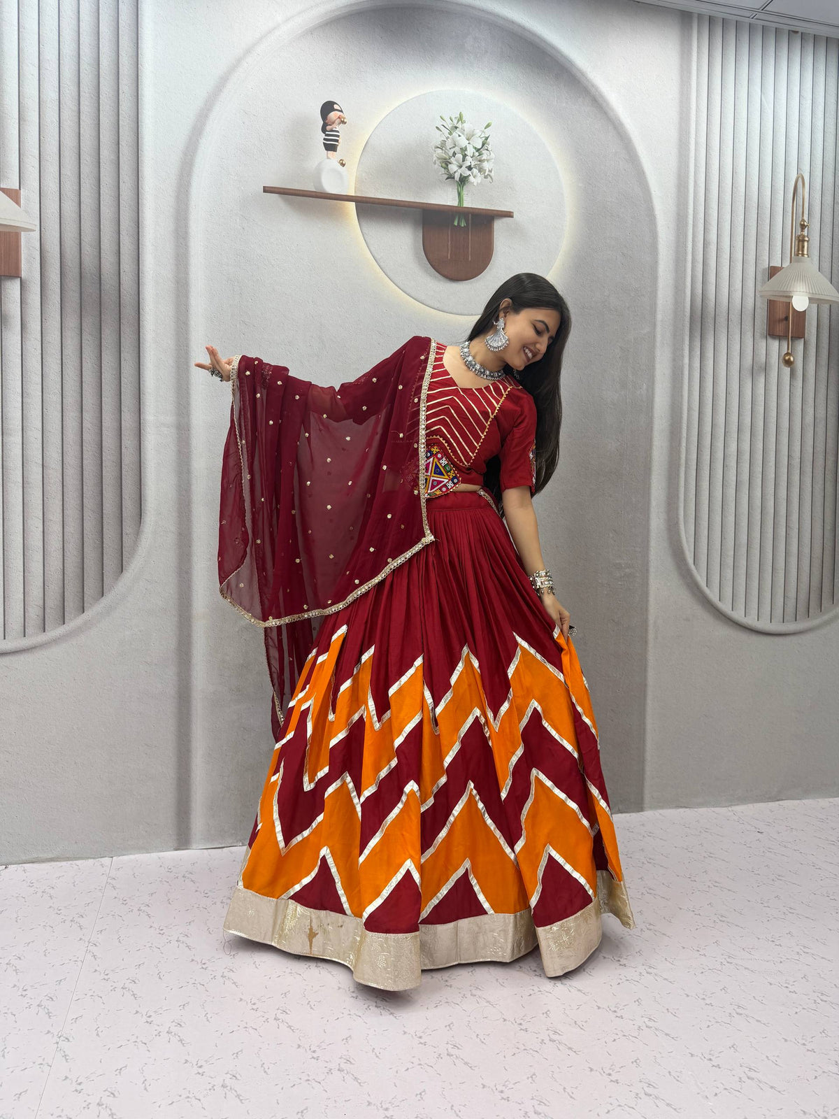 Maroon & Bright Orange Rayon Cotton Zig-Zag Chevron Pattern Navratri Special Flared Lehenga Choli Set With Real Mirror Work Blouse & Dupatta