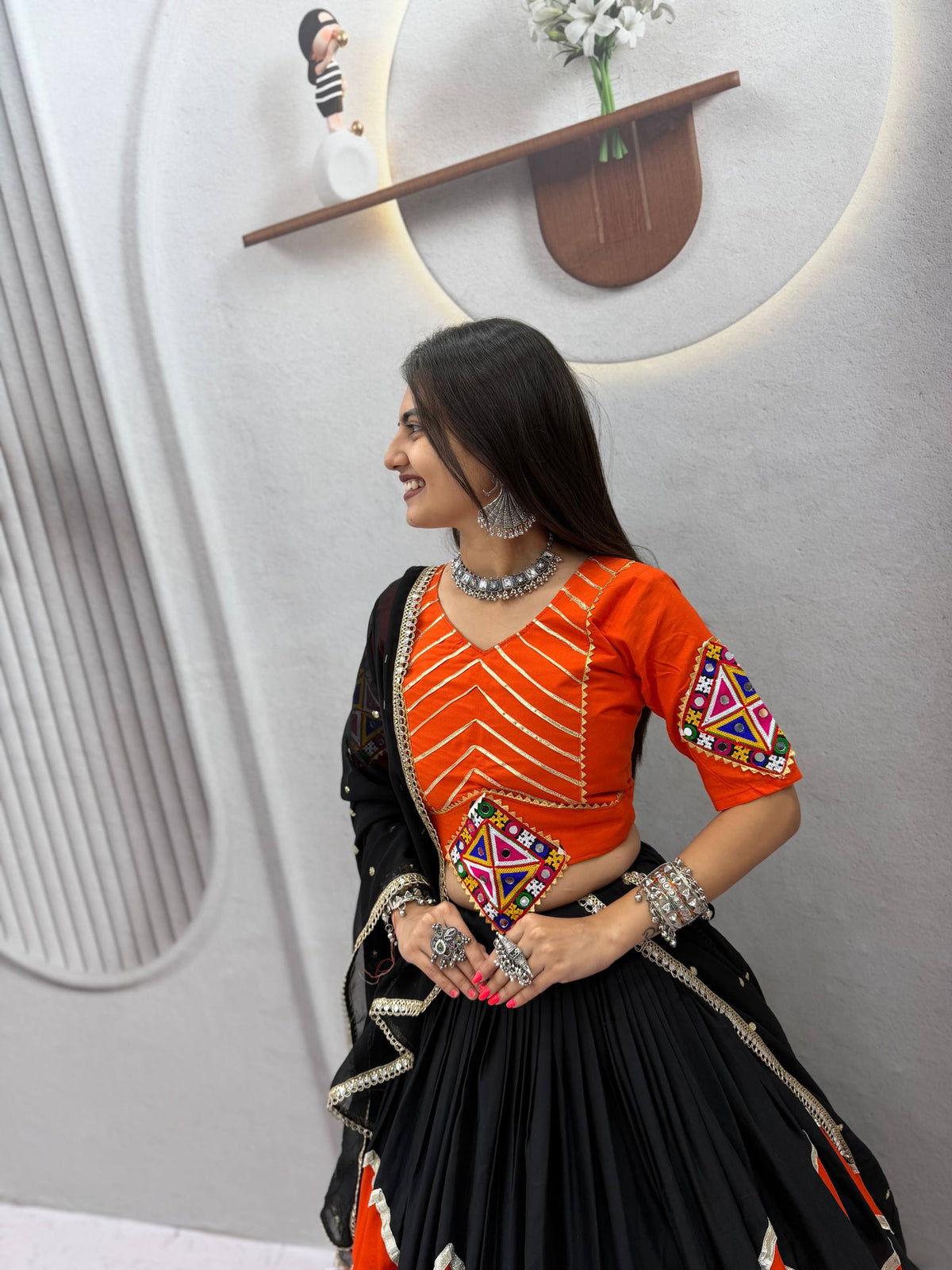 Classic Black & Vibrant Orange Rayon Cotton Zig-Zag Chevron Pattern Navratri Special Flared Lehenga Choli Set With Real Mirror Work Blouse & Dupatta
