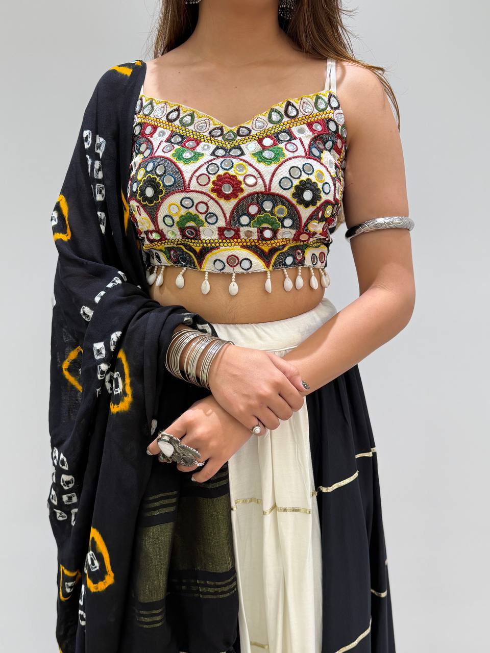 White & Black Rayon Real Mirror Embroidery Navratri Lehenga Choli With Bandhani DupattaWhite & Black Rayon Real Mirror Embroidery Navratri Lehenga Choli With Bandhani Dupatta