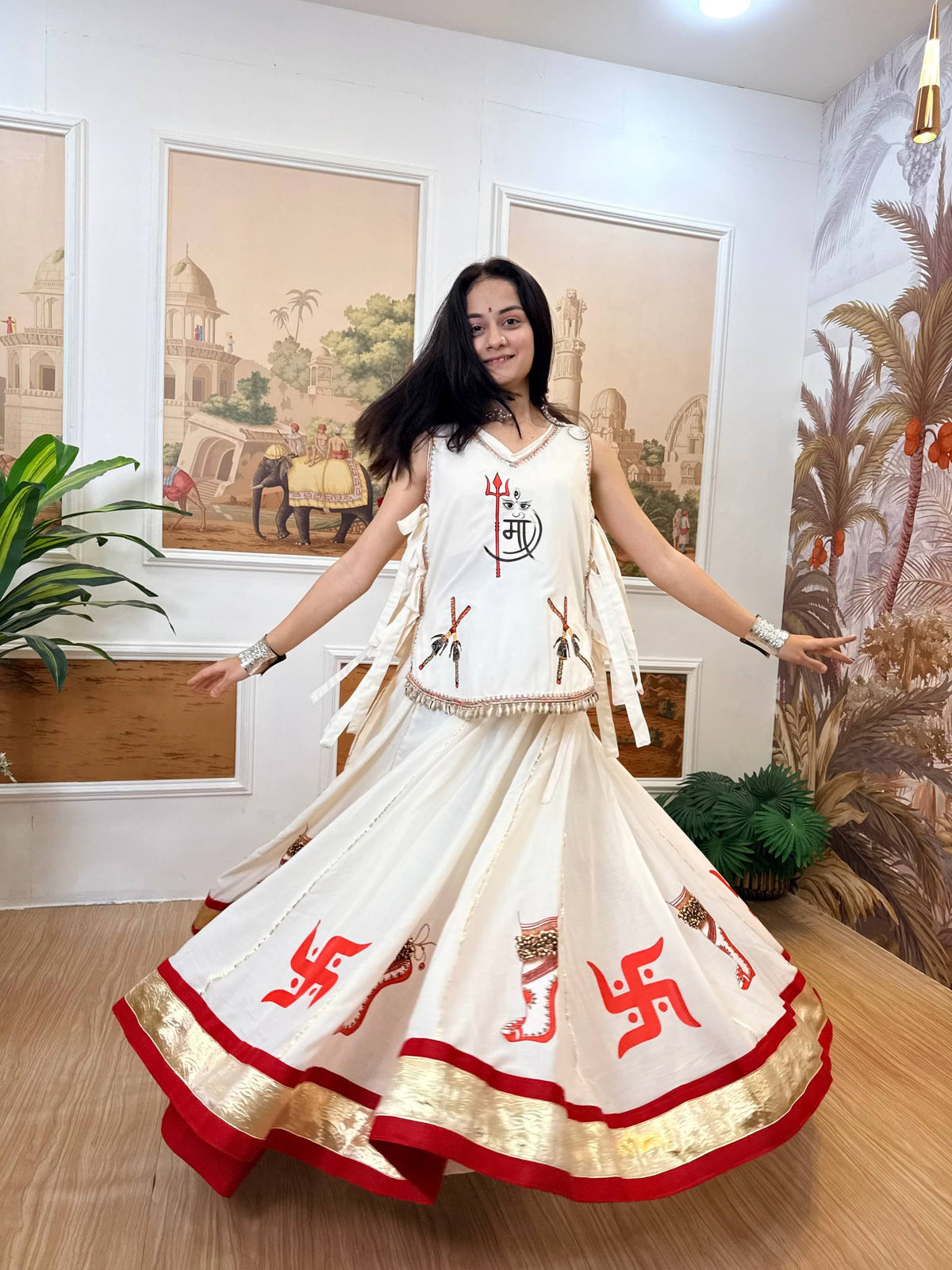 Off-White & Red Pure Cotton Hand Print Swastik Motifs Navratri Lehenga Choli Set With Fancy Kodi Shell Lace & Side Dori Pattern