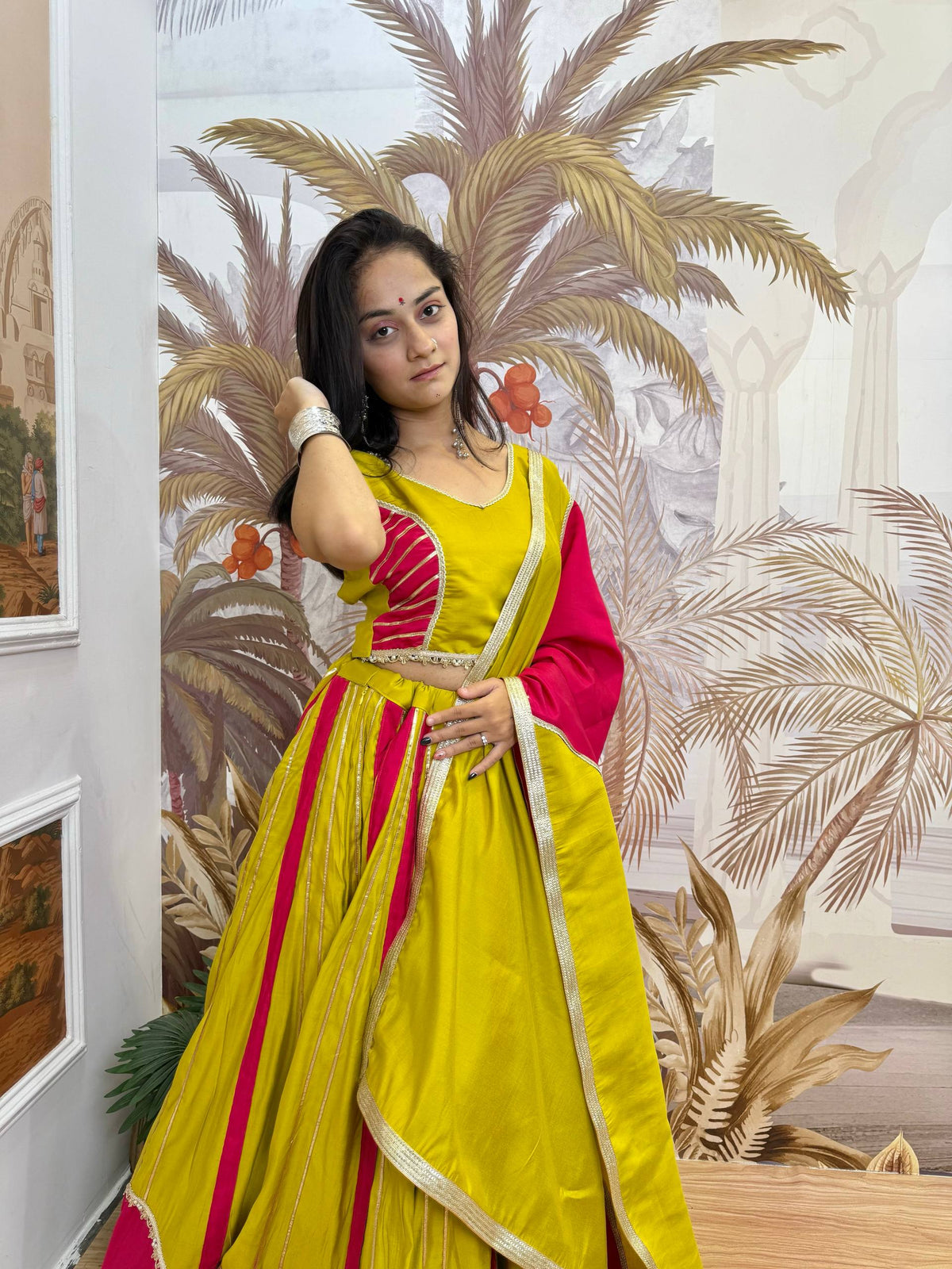 Lime Yellow & Rani Pink Roman Silk Panel Pattern Navratri Special Flared Lehenga Choli Set With Fancy Lace Work & Dupatta