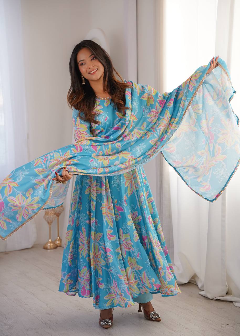 Sky Blue Floral Printed Muslin Cotton Anarkali Flared Gown Suit Set with Embroidered Neckline, Micro Cotton Inner, Matching Pants & Multi-Color Lace Dupatta