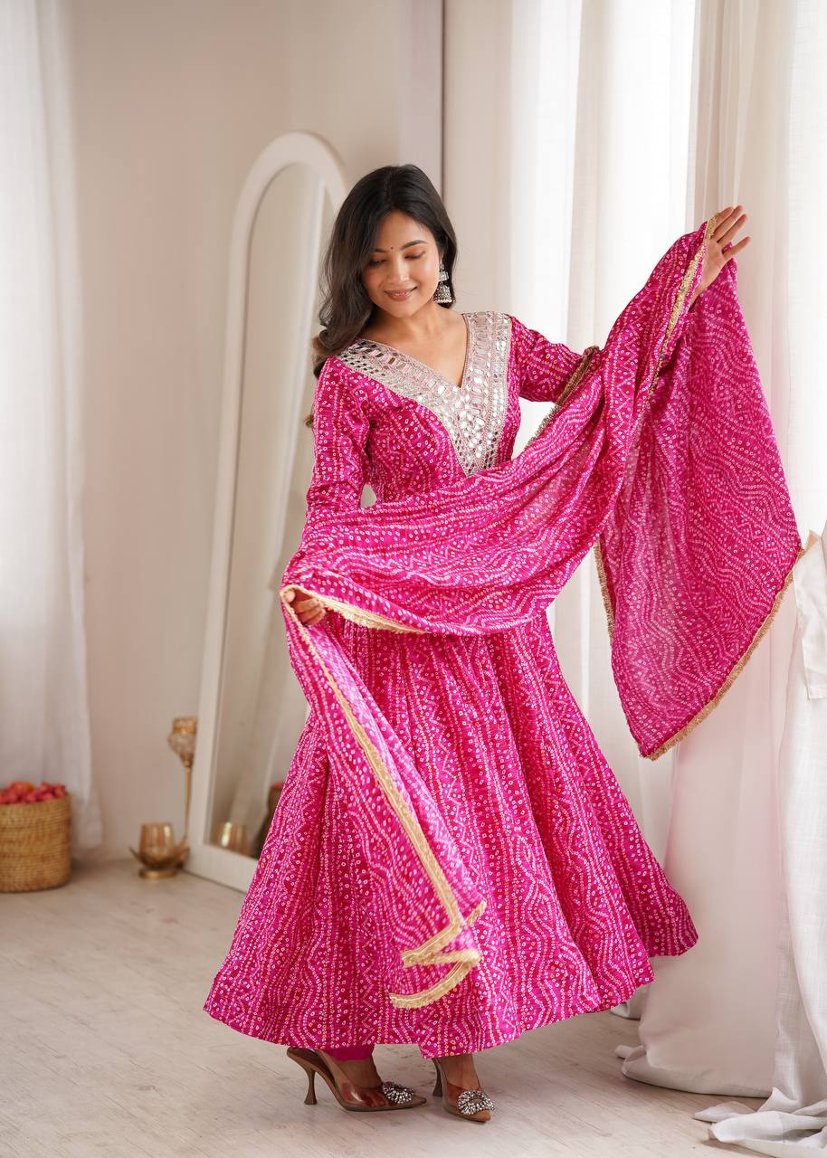 Rani Pink Rayon Bandhani Print Anarkali Gown Suit Set with Heavy Real Mirror Embroidery V-Neck Yoke, Matching Pants & Golden Lace Rayon Dupatta (2.3M)