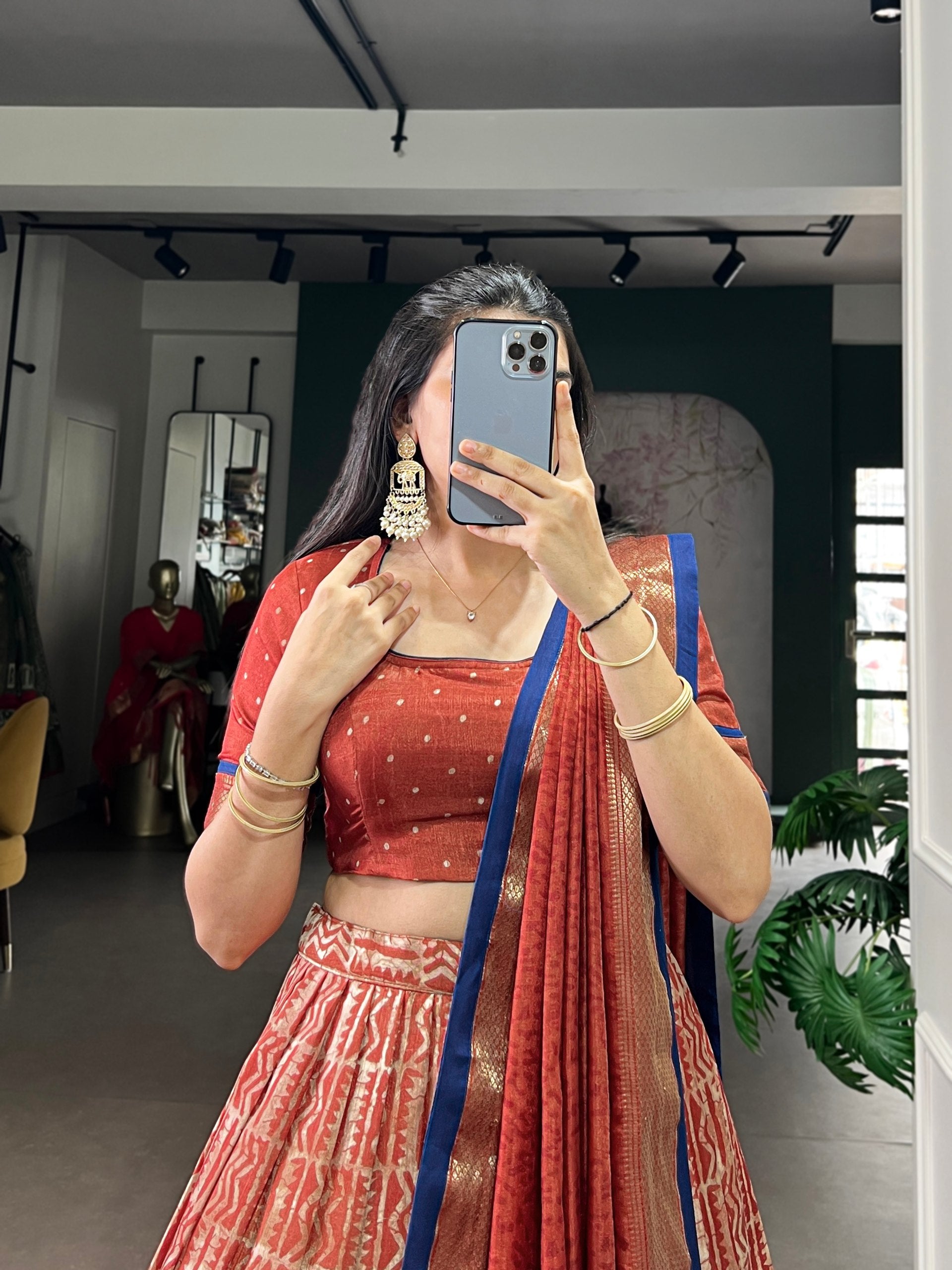 Rust Orange Dola Silk Flared Lehenga Choli Set with Traditional Batik Print, Rich Zari Weaving Border & Royal Blue Contrast Dupatta
