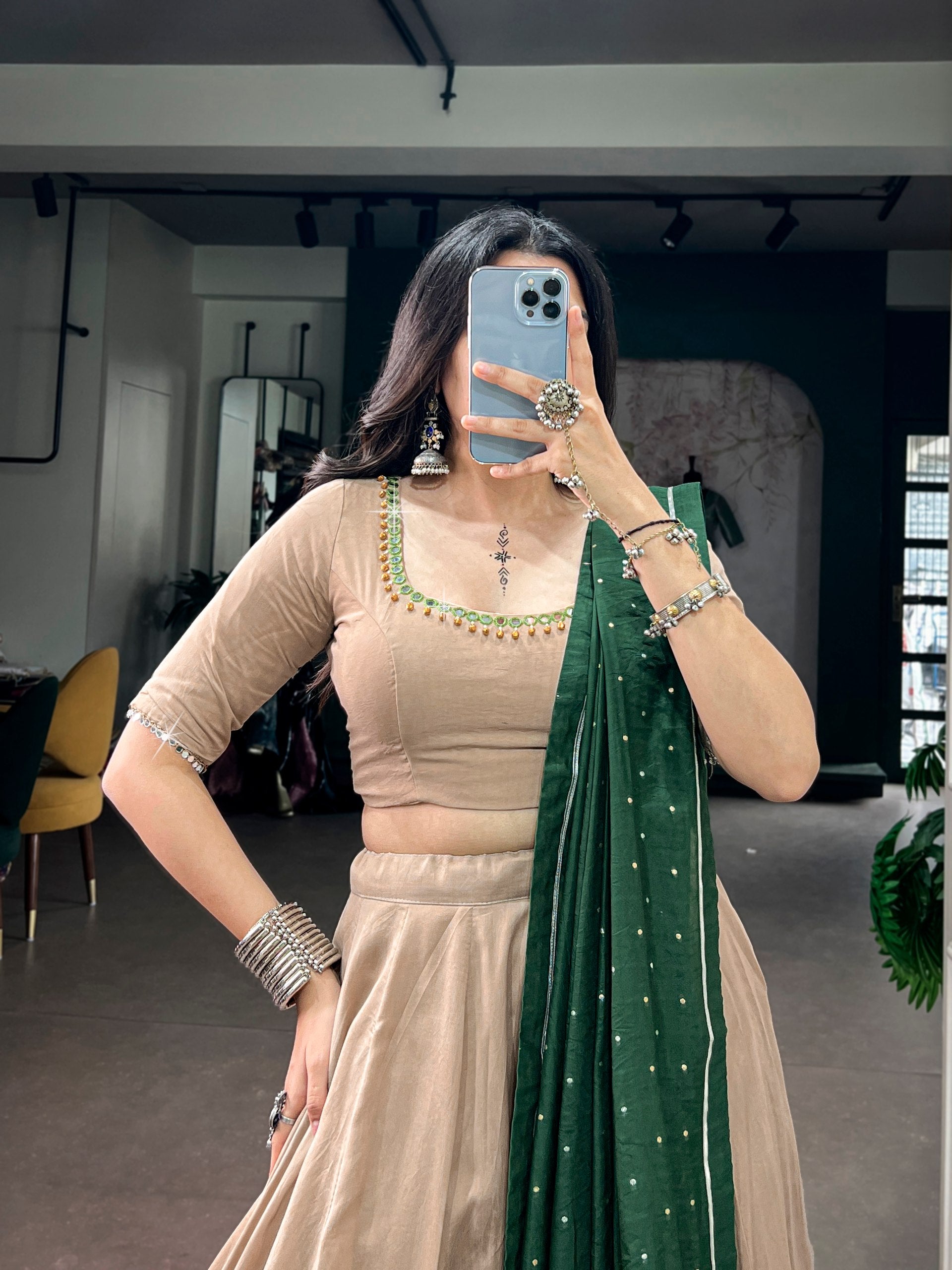 Beige Chanderi Silk Flared Navratri Lehenga Choli Set with Intricate Green Embroidered Border & Back-Embellished Mirror Work Blouse with Dupatta