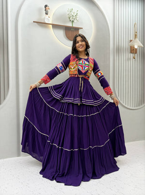 Model Posing Indoors Wearing Purple Pure Cotton Heavy Gamthi Work & Mirror Lace With Sikka Lace Navratri Lehenga Choli Set By The Beauty Queen