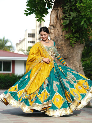 Model twirling in Teal Blue & Mustard Yellow Heavy Muslin Cotton Real Mirror Work With Handmade 8 Mtr Kodi Lace Navratri Lehenga Choli Set by The Beauty Queen