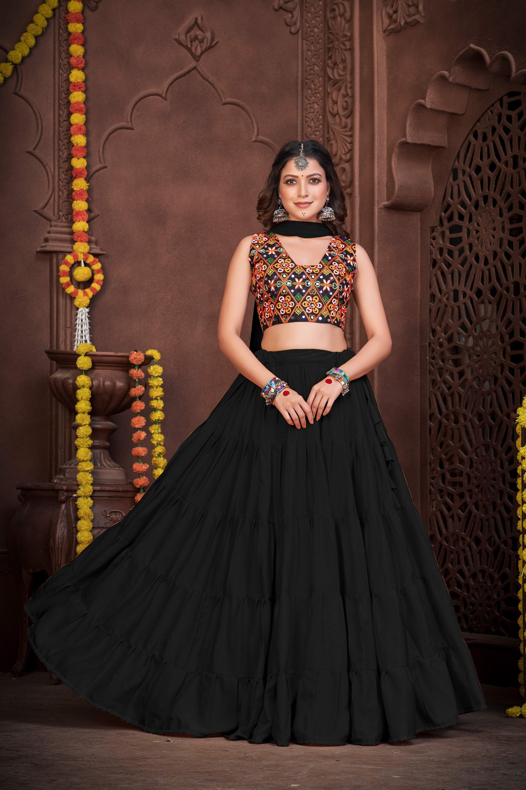 Black French Crape Navratri Lehenga Choli with multi-color Kutchi embroidery and mirror work blouse by The Beauty Queen