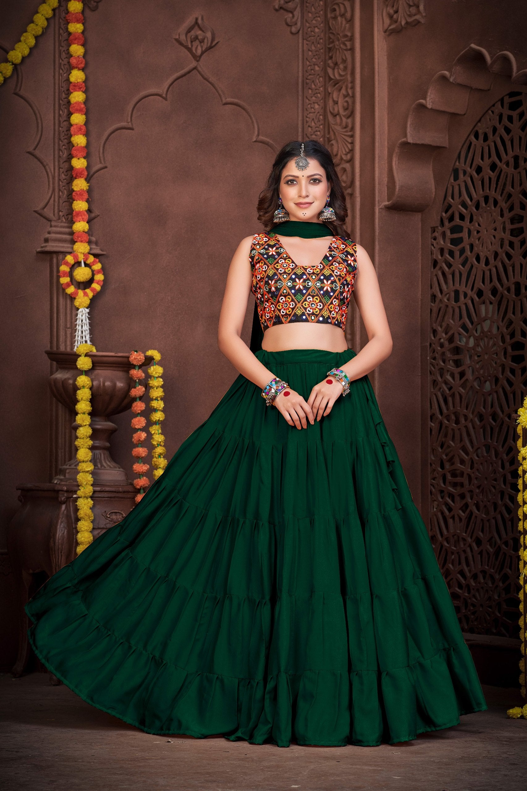 Bottle Green French Crape Navratri Lehenga Choli with multi-color Kutchi embroidery and mirror work blouse by The Beauty Queen
