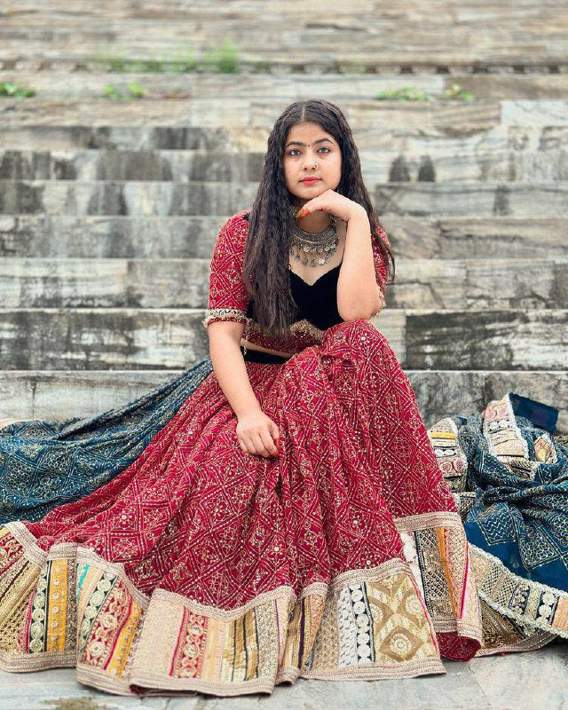 Maroon Red heavy muslin cotton Navratri lehenga choli with bandhani digital print, real mirror work embellishments, and a contrasting teal blue printed dupatta