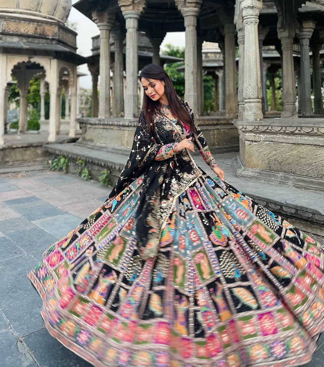 Black heavy muslin cotton Navratri lehenga choli featuring vibrant Kutchi digital prints, real mirror work embellishments, and a full-sleeved blouse