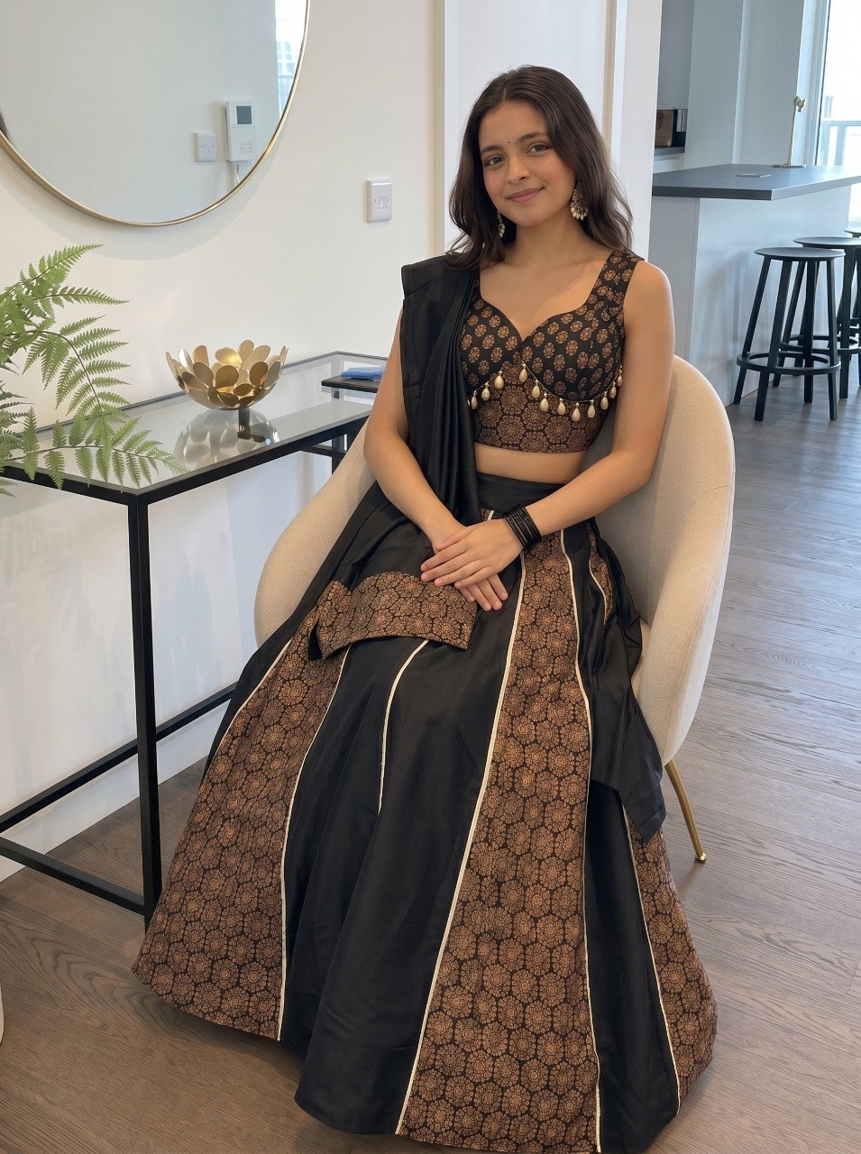 Stitched black Navratri lehenga with cowrie shell tassels

