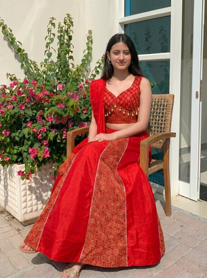 Stitched red Ajrakh lehenga with cowrie shell tassels
