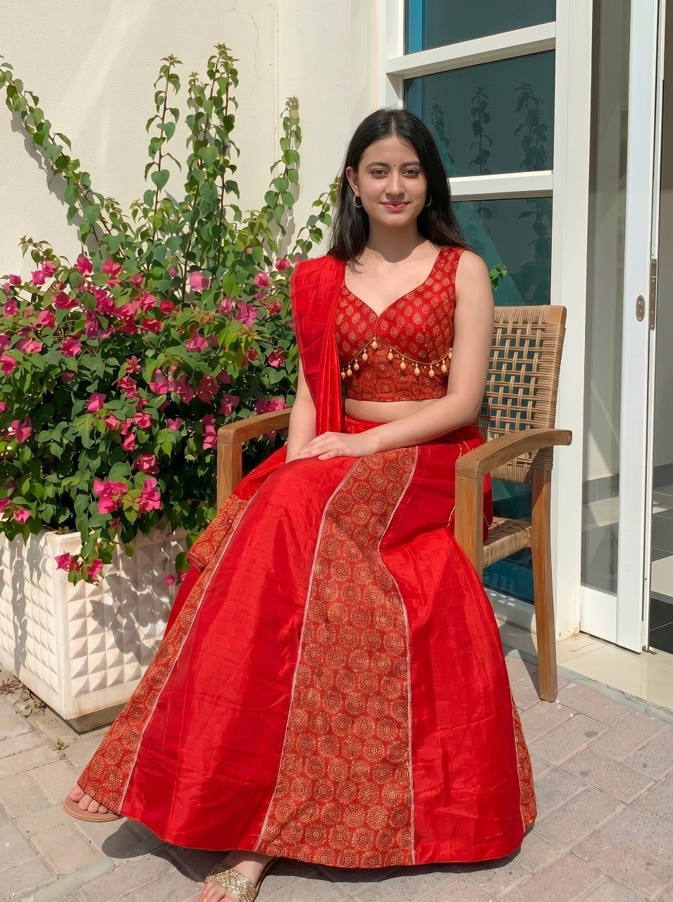 Stitched red Ajrakh lehenga with cowrie shell tassels
