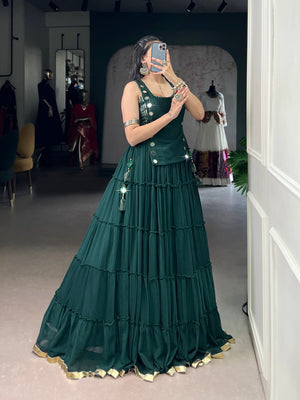 Deep green designer chaniya choli with mirror detailing and gold border
