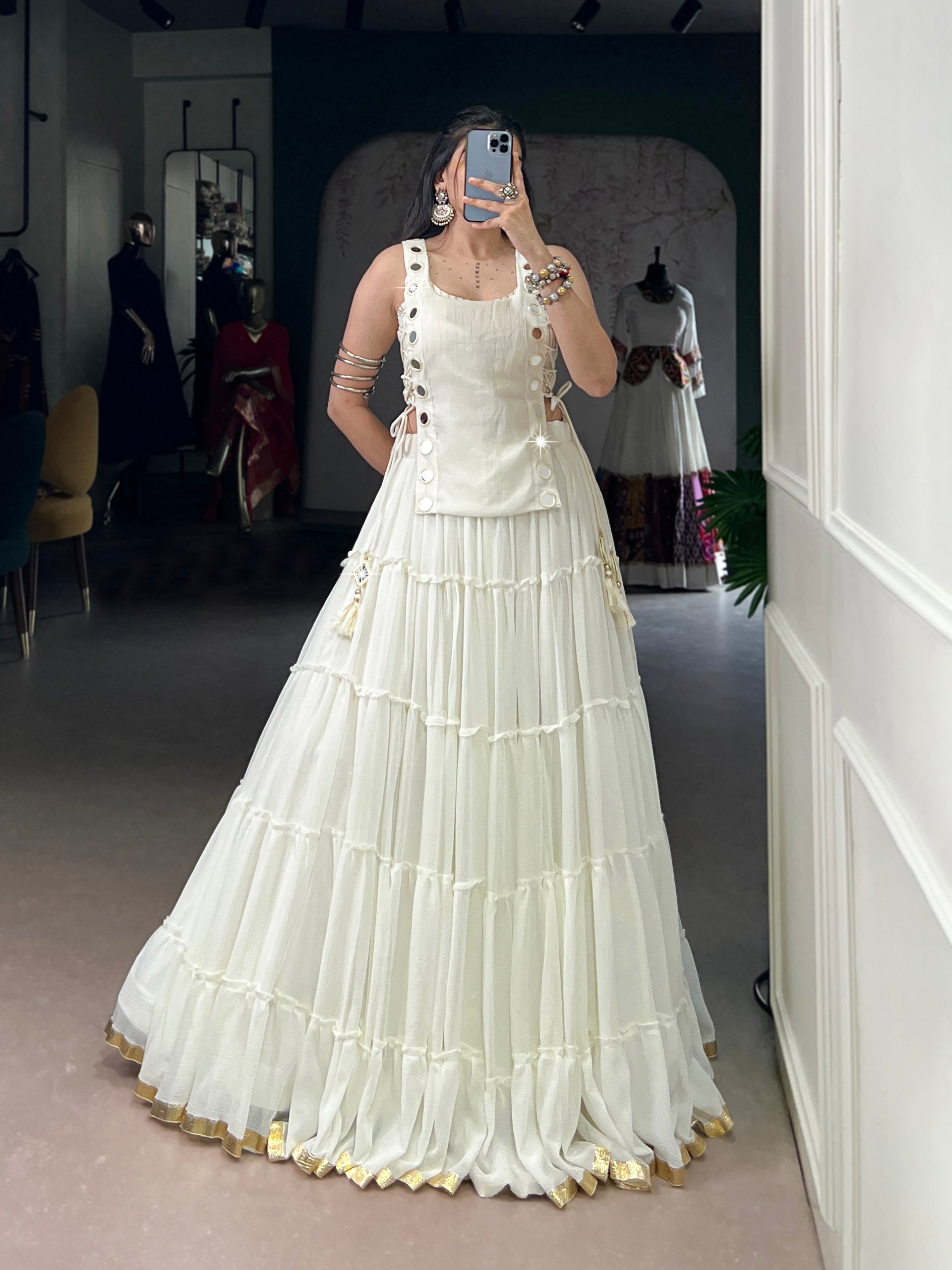 Pristine ivory designer chaniya choli with mirror detailing and gold border
