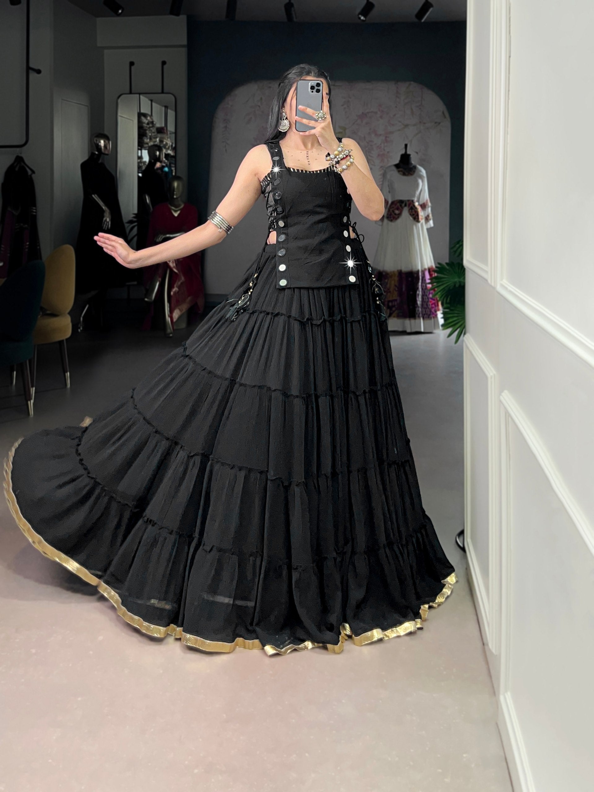 Bold black designer chaniya choli with mirror detailing and gold border
