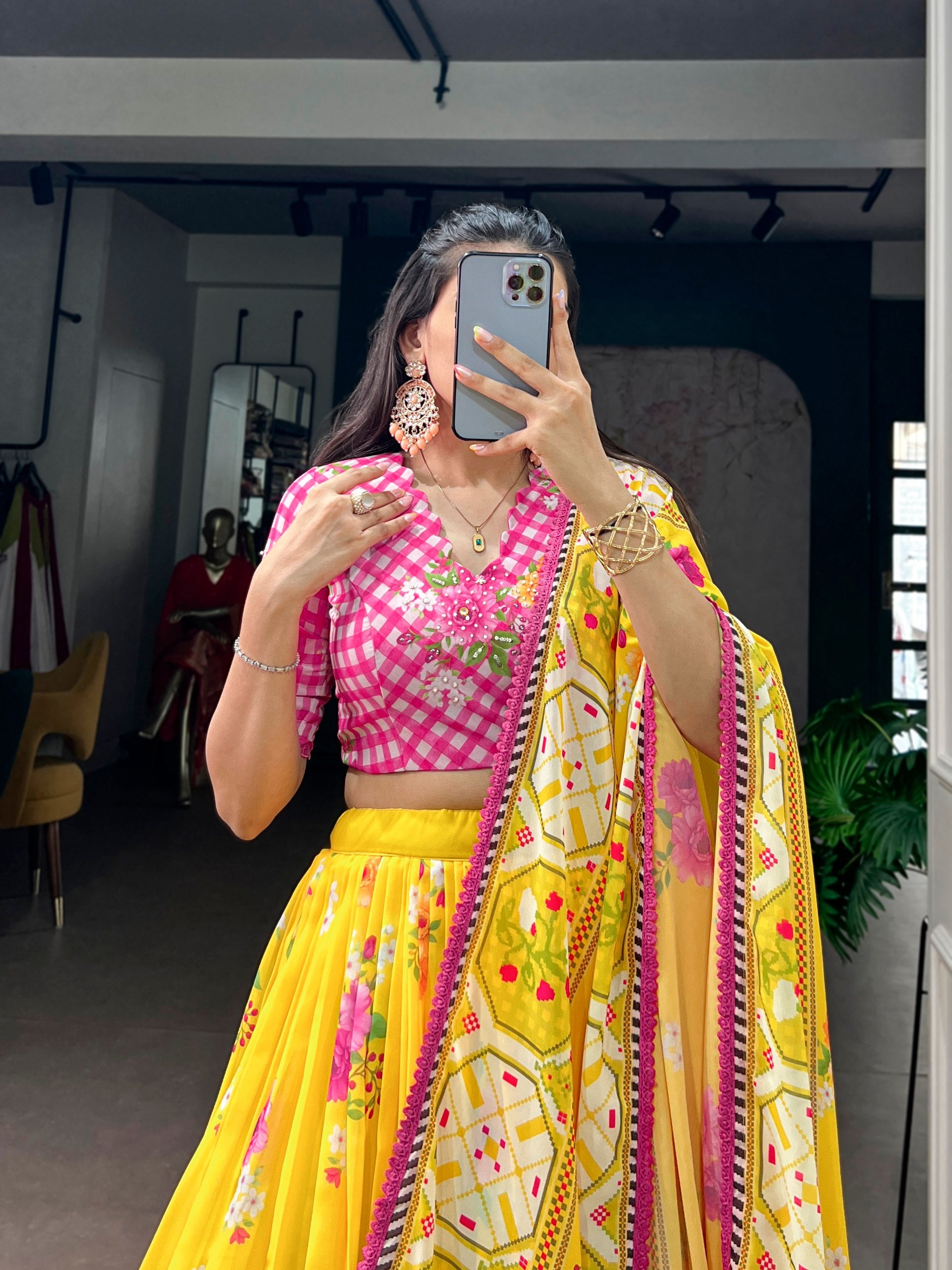 Yellow flared lehenga with multicolour floral print and pink checkered blouse
