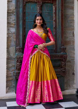 Mustard yellow Narayan Pattu silk half saree with pink and gold zari weaving border
