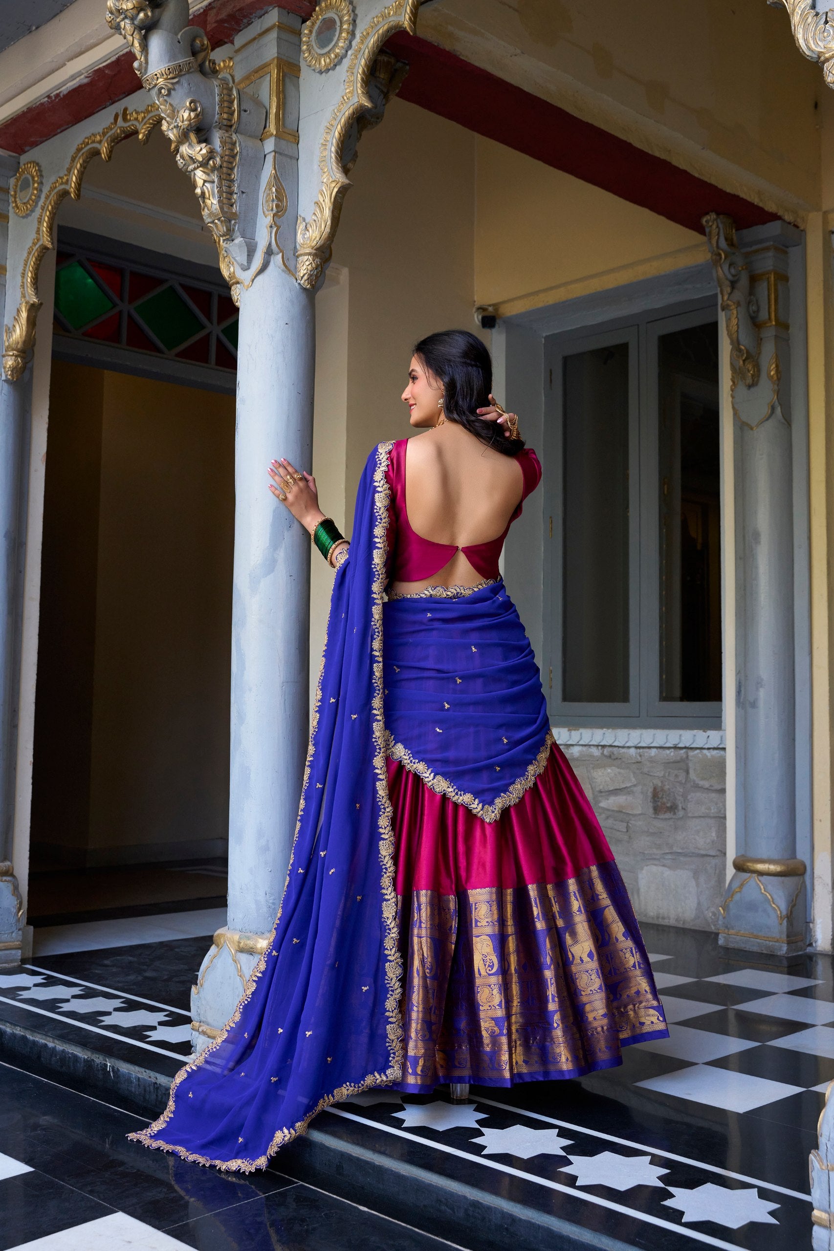 Traditional South Indian half saree rani pink with gold zari and blue dupatta
