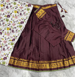 Brown South Indian half saree with temple patta border and off-white floral dupatta
