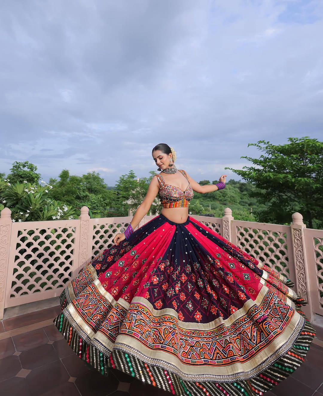 Navy blue and Rani pink heavy malai silk Navratri lehenga choli featuring dual-tone panels, digital print, real mirror work, and golden gota zari lace borders
