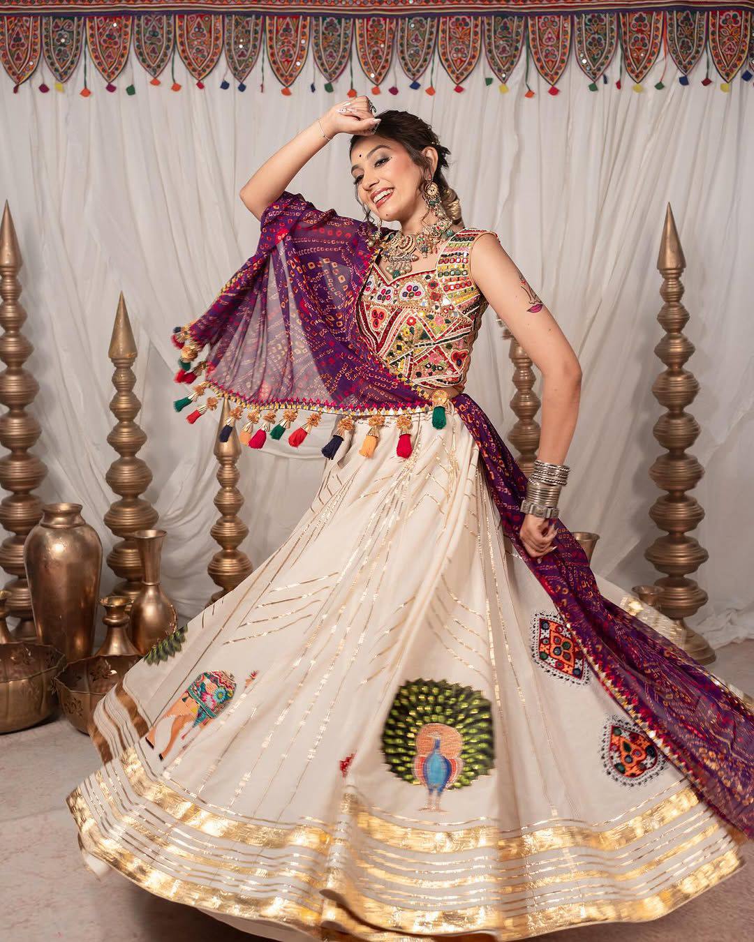 Garba chaniya choli cream with Kutchi mirror work blouse and purple bandhani dupatta
