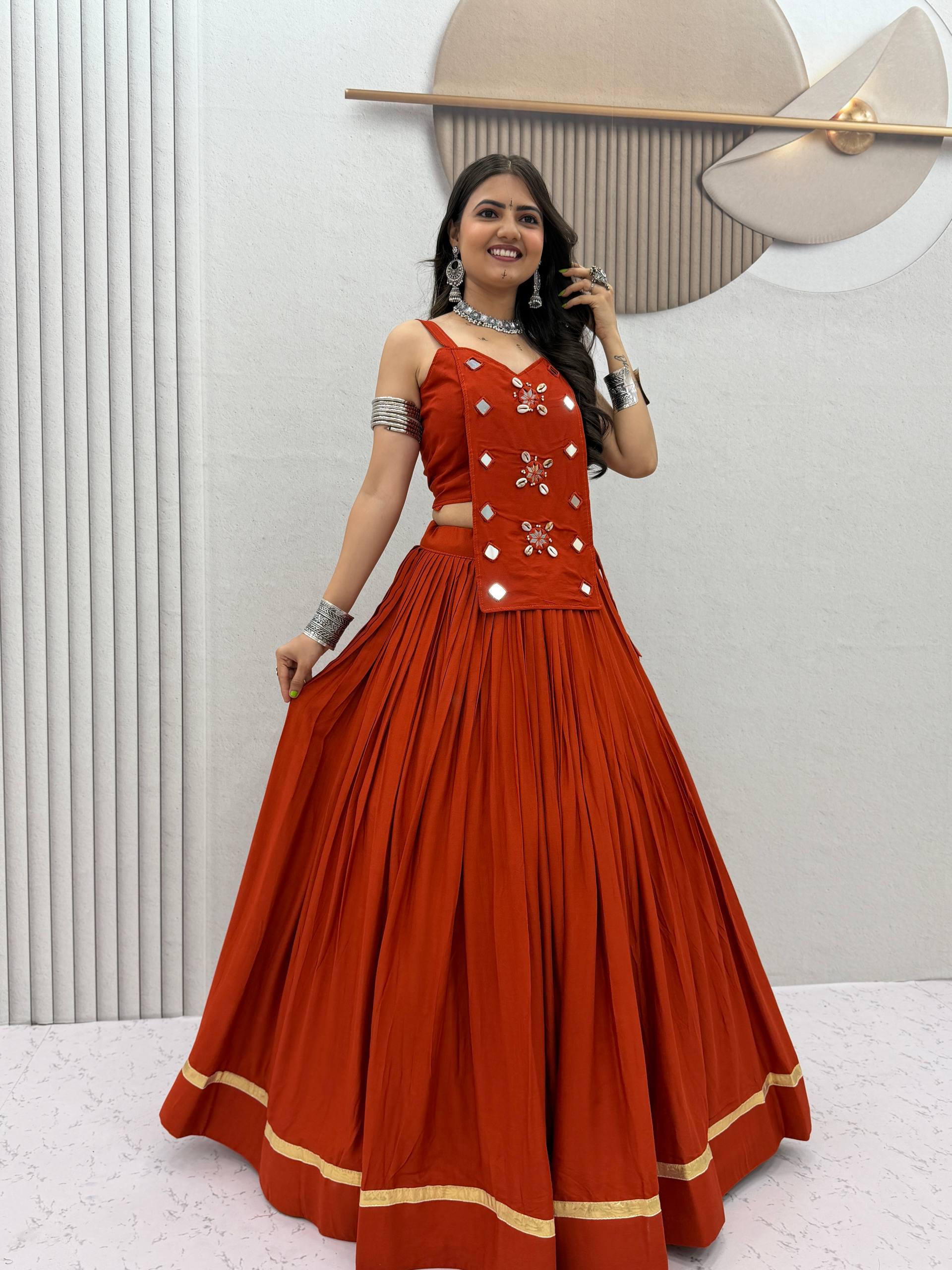 Rust orange pure cotton Navratri lehenga choli with real kodi and mirror hand work
