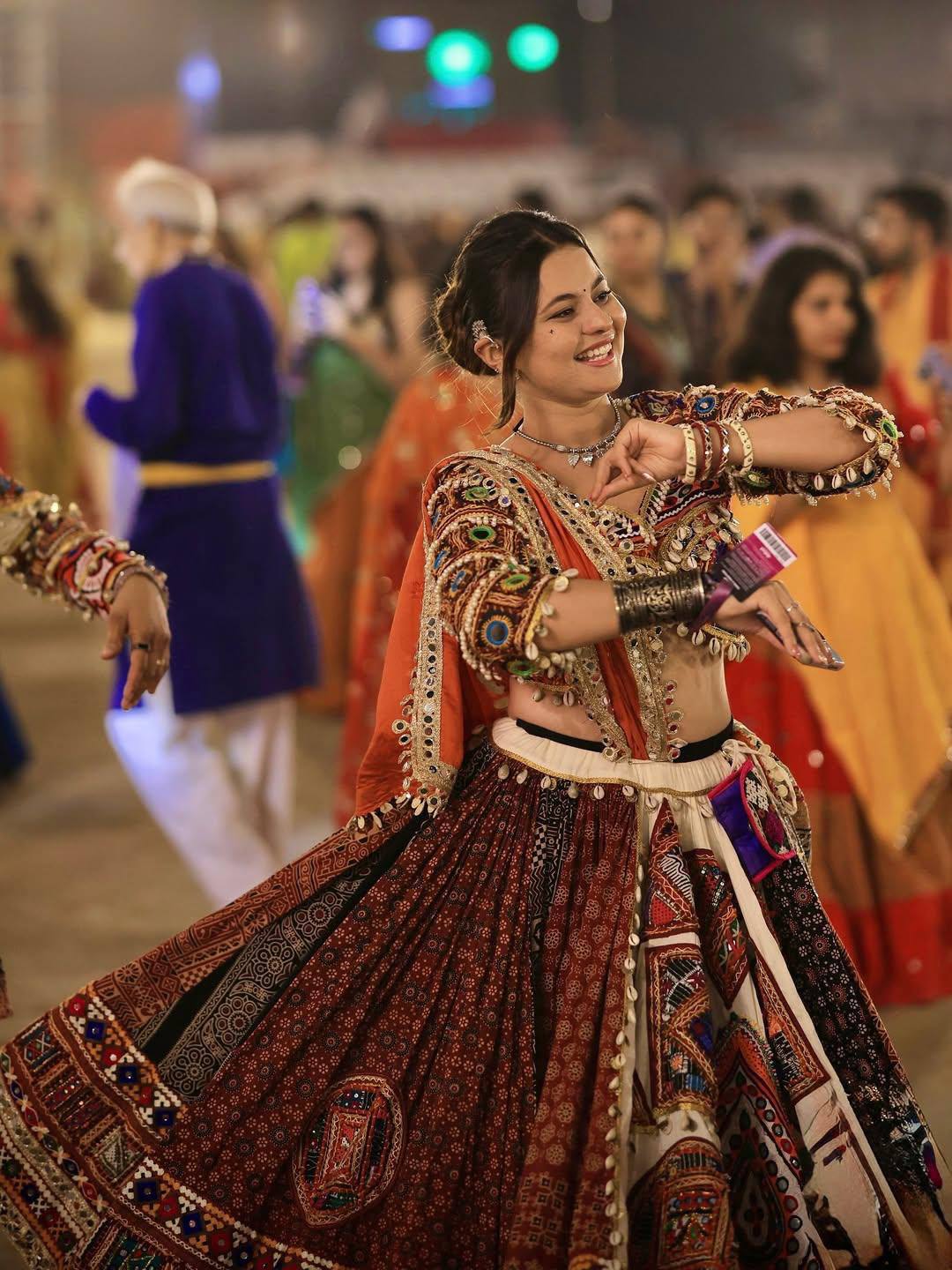 Muslin cotton traditional Navratri lehenga choli featuring Kutchi-style multi-panel digital prints, real mirror work embellishments, and a shell-tasseled blouse