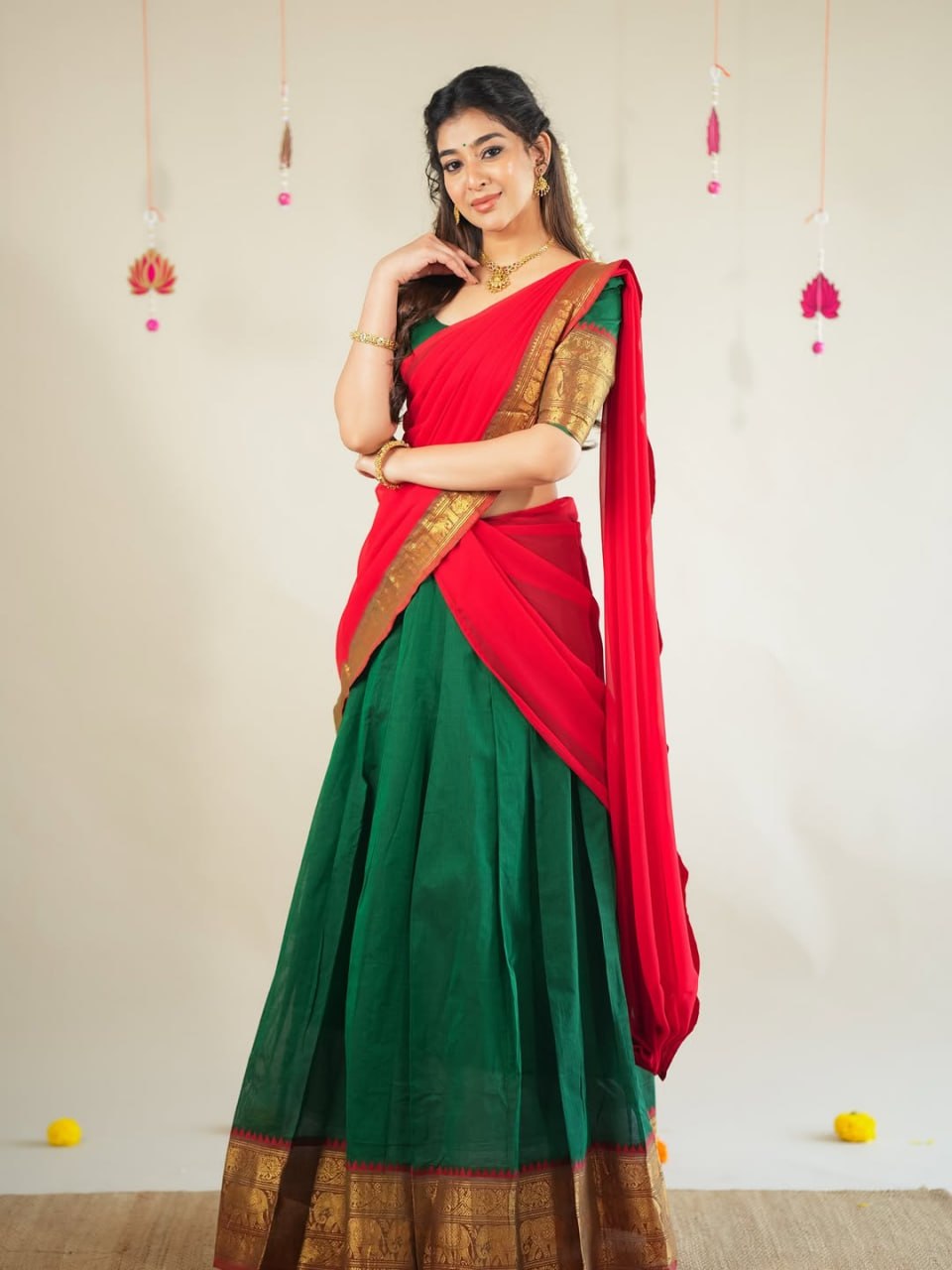 Traditional half saree with woven gold zari border green red

