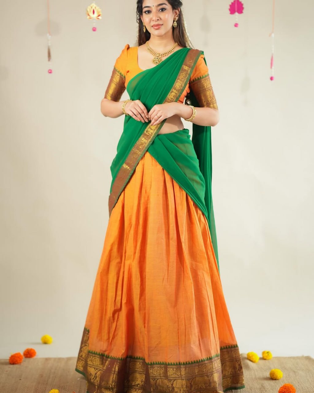 Traditional half saree with woven gold zari border orange green
