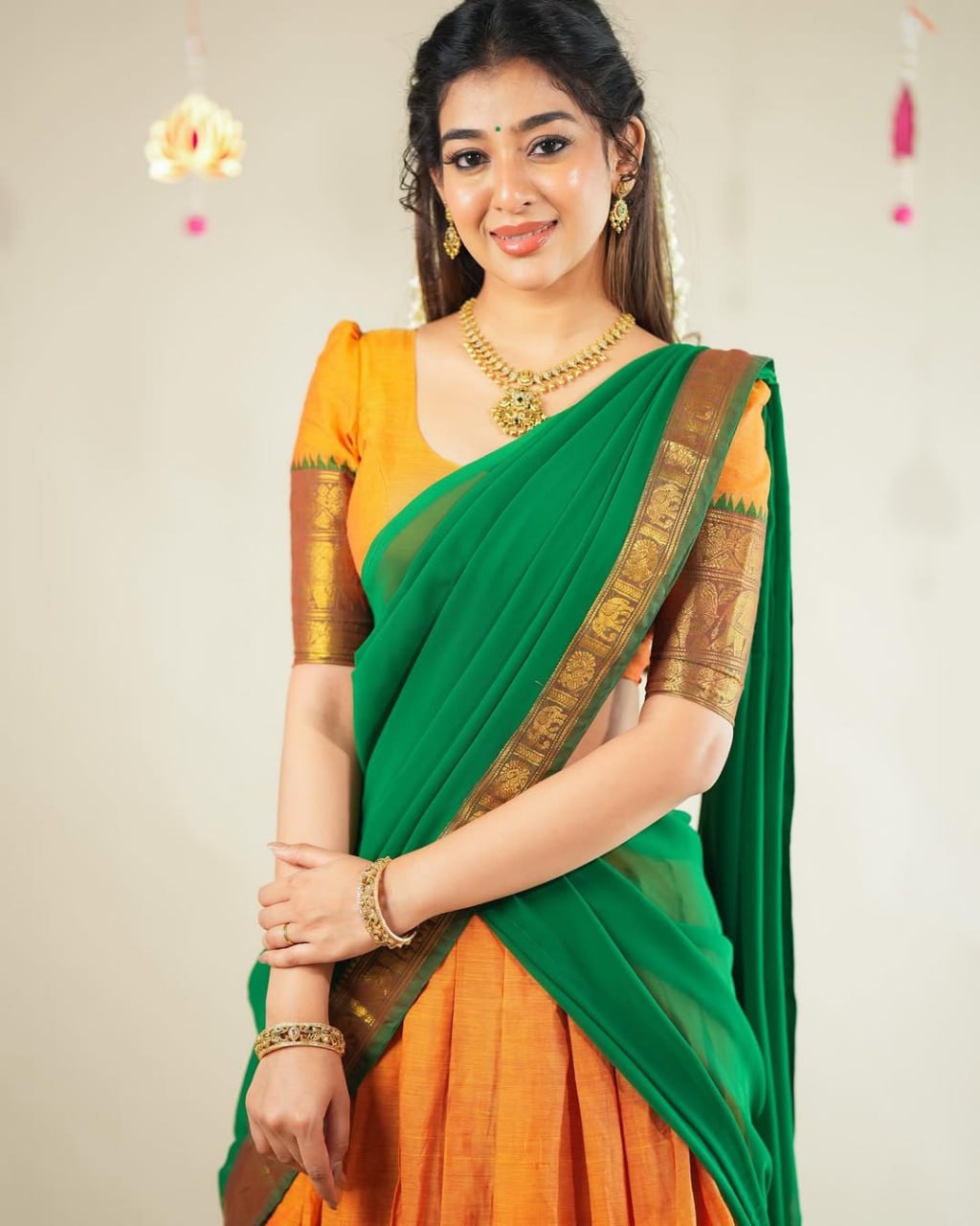 South Indian langa voni in orange Kanchi cotton with green dupatta
