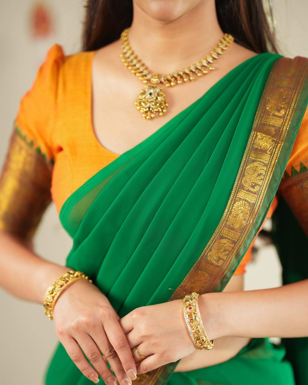 Classic South Indian half saree lehenga orange with emerald green contrast
